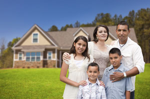 Hispanic family in front of home