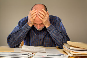 Man overwhelmed with paperwork